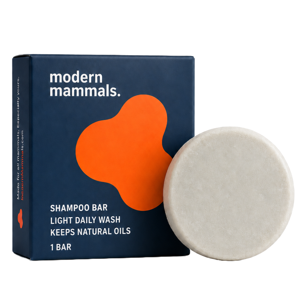 Front view of Shampoo Light Bar showing navy box with orange logo and round pale bar on white background